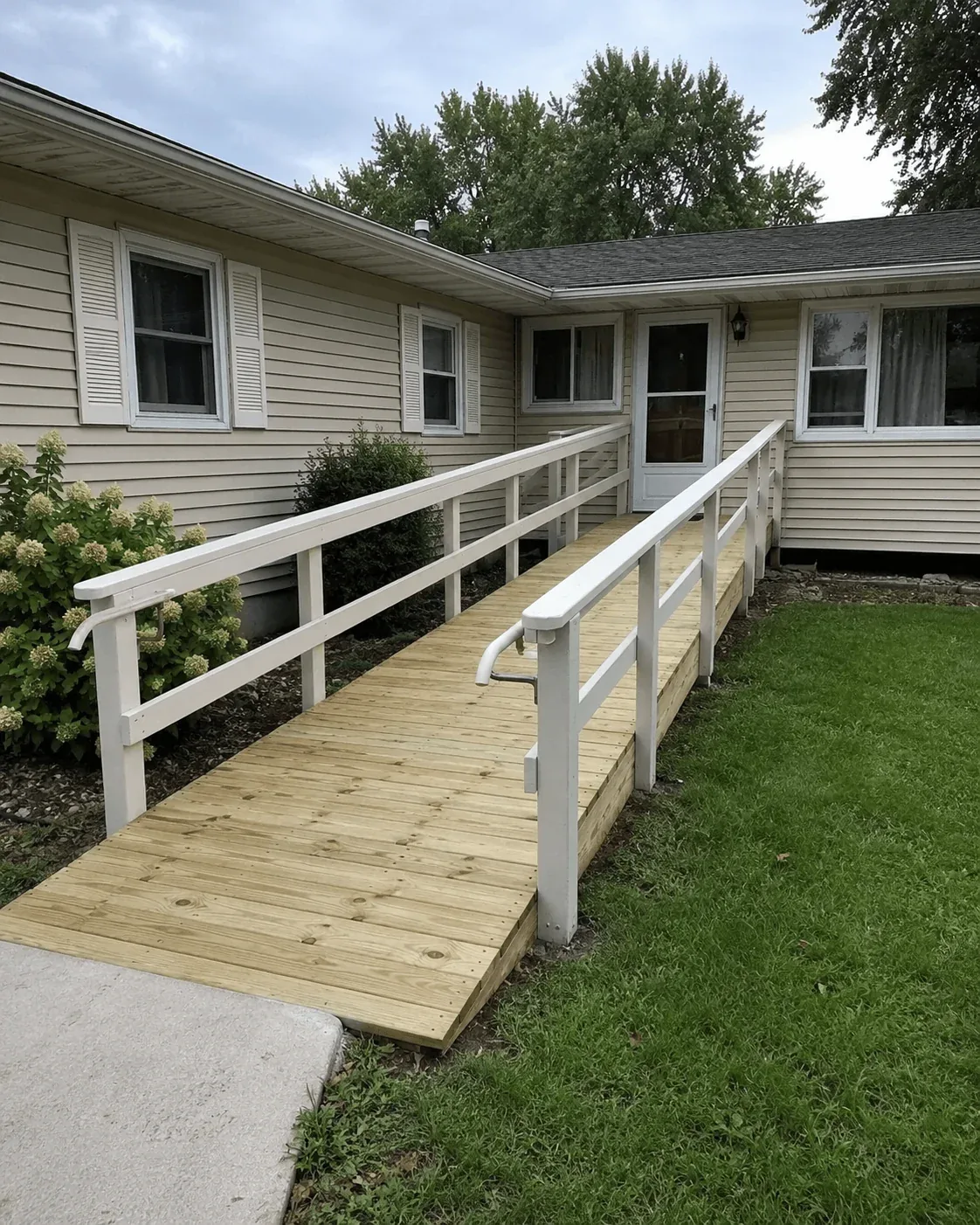 Wooden access ramp with handrails at the entry of a Comox Valley home